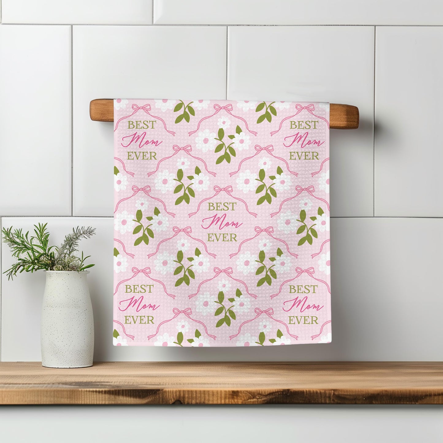 a towel hanging on a wall next to a potted plant