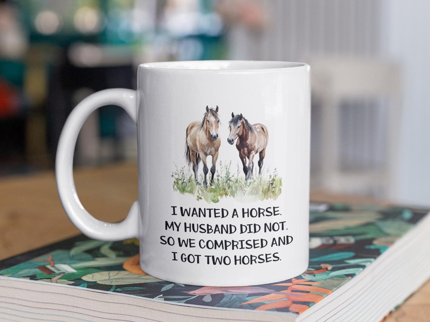 a white coffee mug with two horses on it