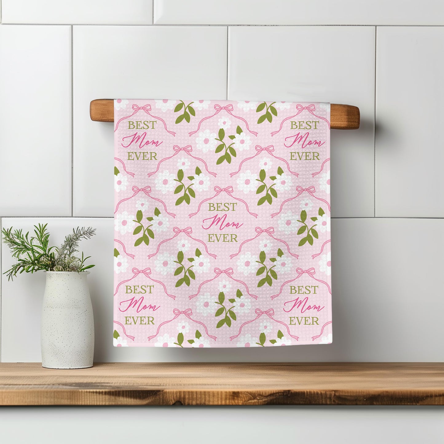 a towel hanging on a wall next to a potted plant