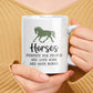 a woman holding a coffee mug with a horse on it