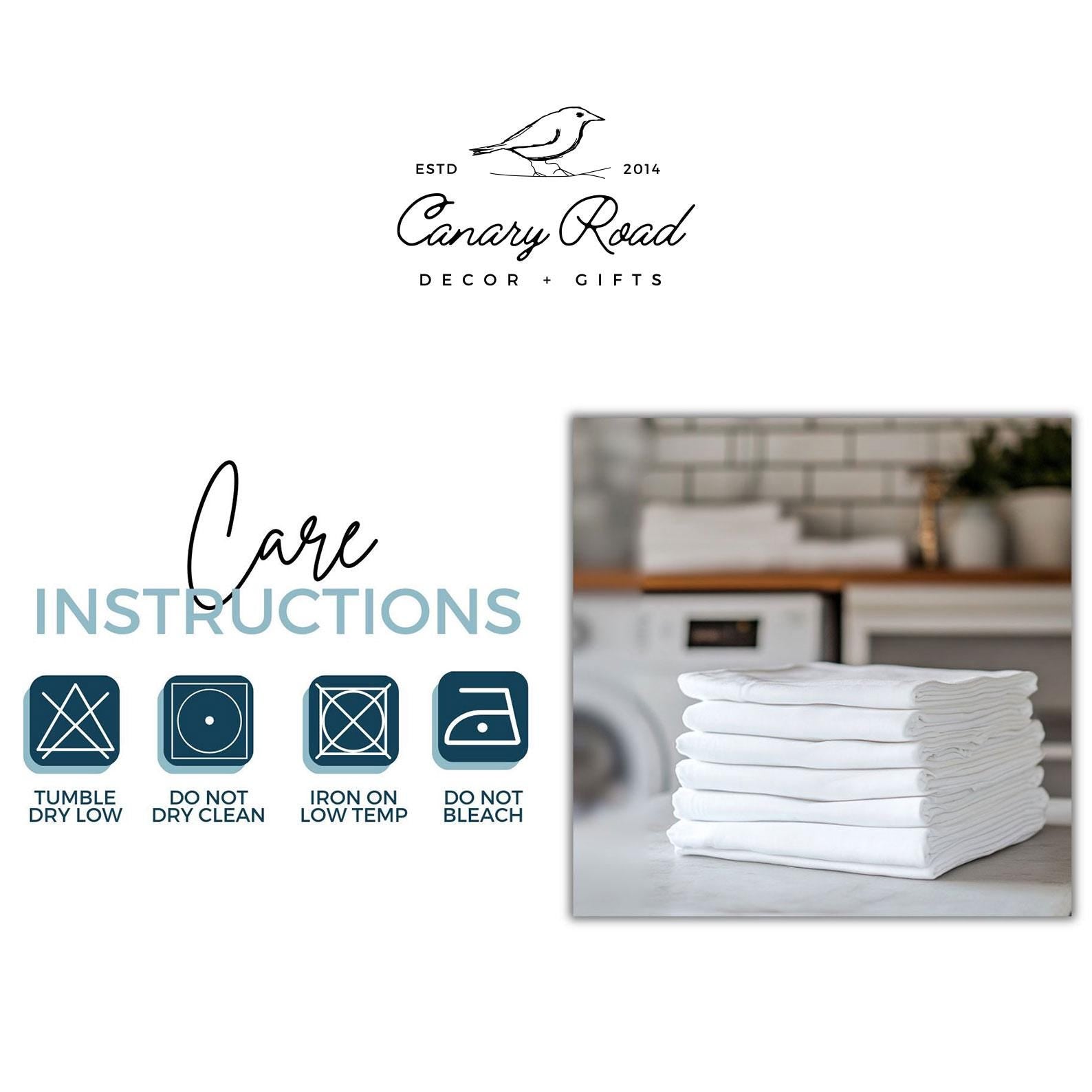 a stack of white towels sitting on top of a table