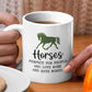 a person holding a coffee mug with a horse on it