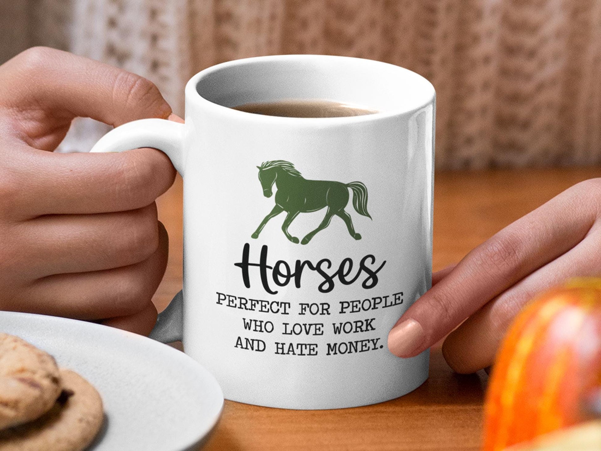 a person holding a coffee mug with a horse on it