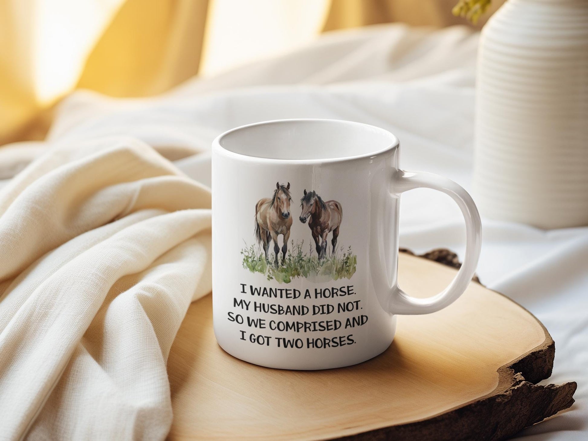 a white coffee mug with two horses on it